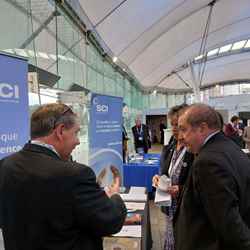 Graeme Dey MSP talks with a representative from SCI as he visits one of the exhibition stalls during a break at Science and the Parliament